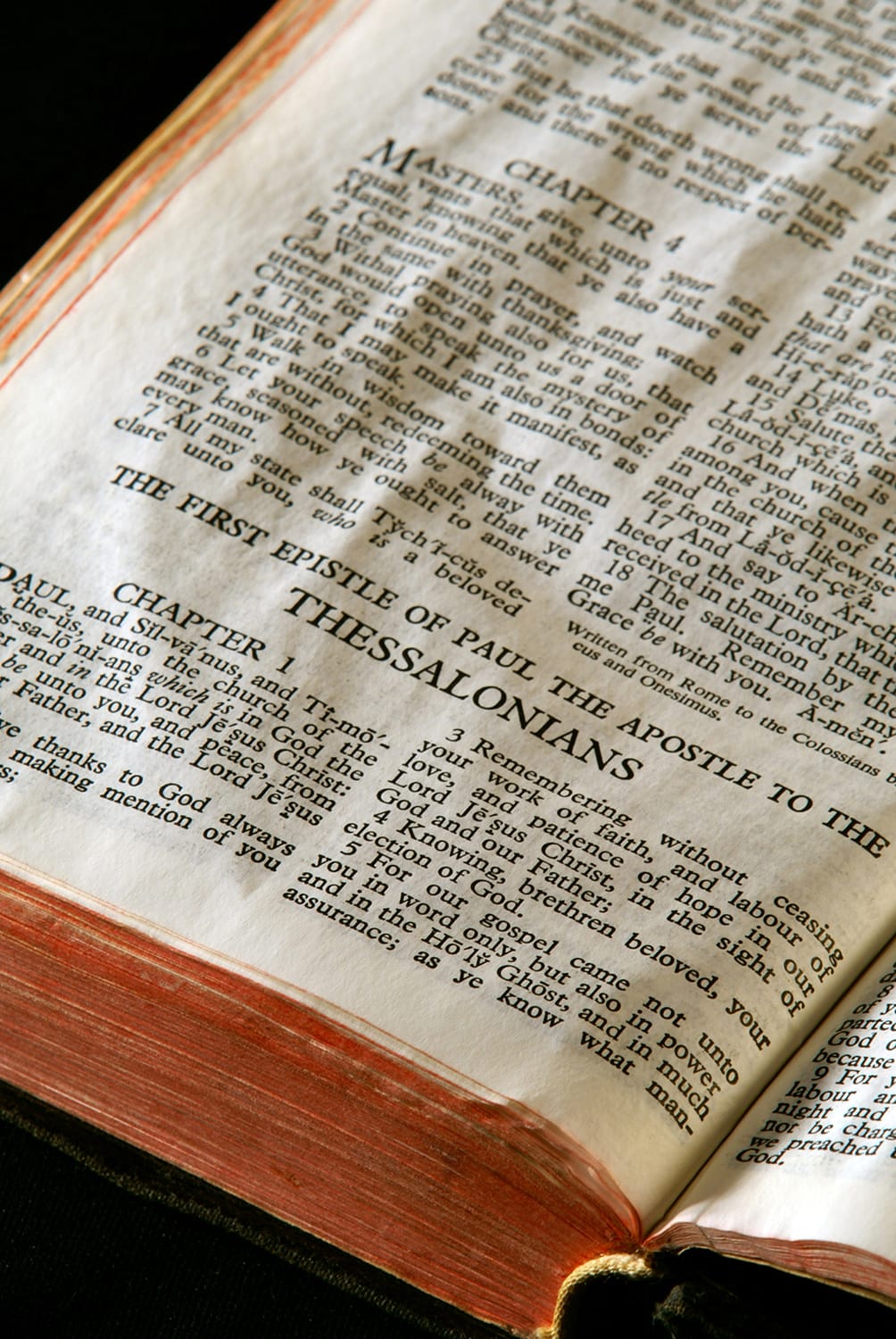 Bible Series. close up detail of antique holy bible open to the gospel according to the first epistle of paul the apostle to the thessalonians in the new testament